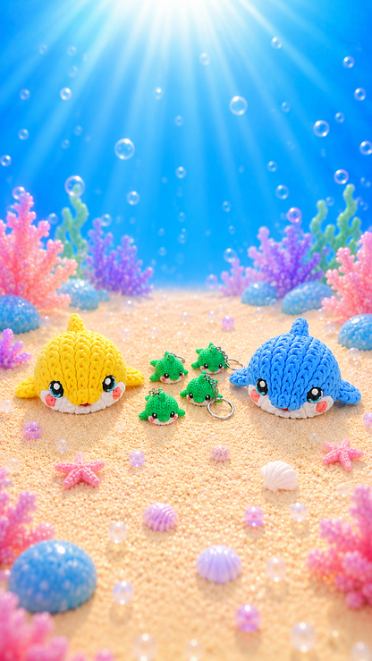 Gestricktes Delfin-Schlüsselanhänger-Set: gelb, blau und mehrere grüne Mini-Delfine mit Schlüsselring
