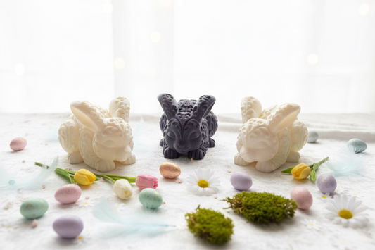 Mehrere Hasen-Ornamente und Deko-Eier auf hellem Untergrund, kleine Figuren-Set